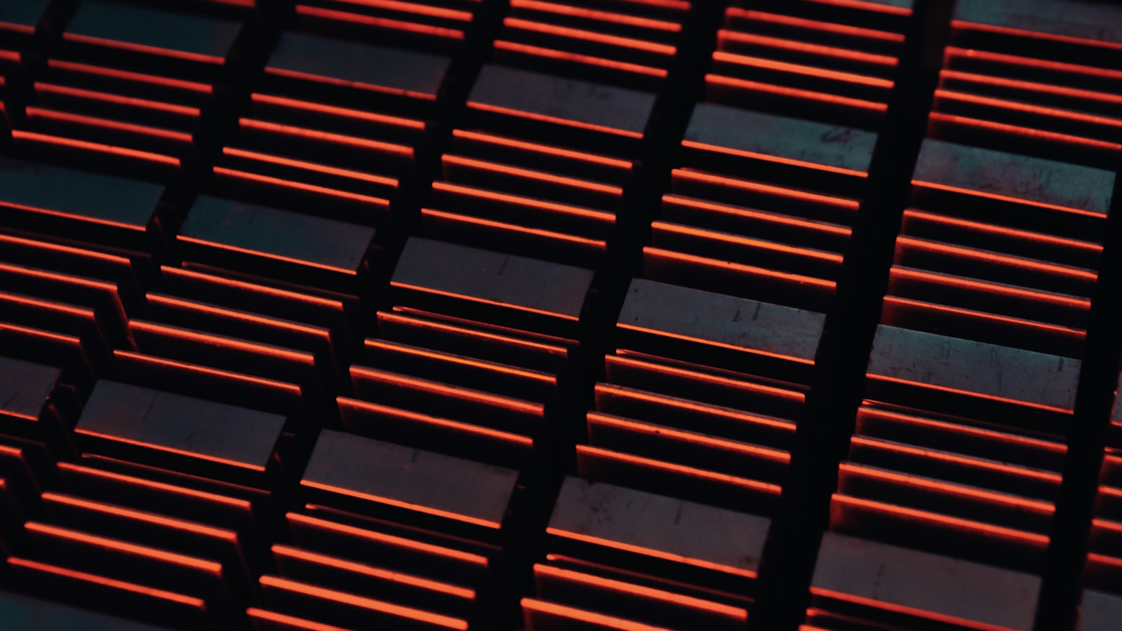 Close-up of an industrial Bitcoin mining rig — red status lights on a metal grate, the kind of hardware that produces hashrate at scale.