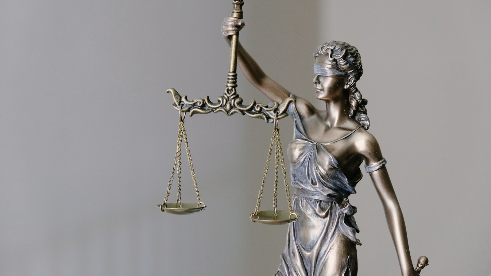 A balance scale weighing two options — Maclear business loans against EstateGuru real estate.